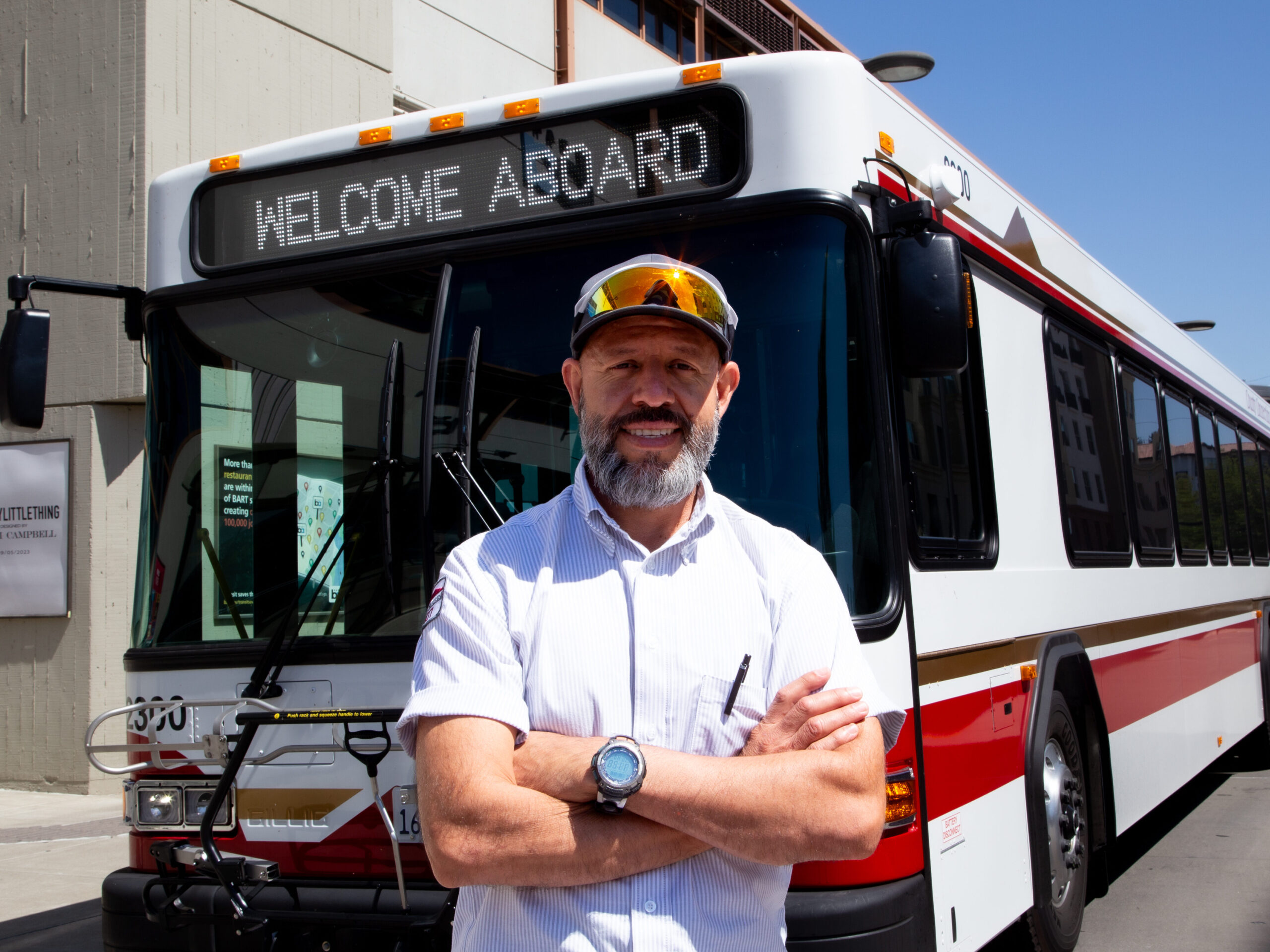 Image of bus driver smiling in front of a County Connection bus.